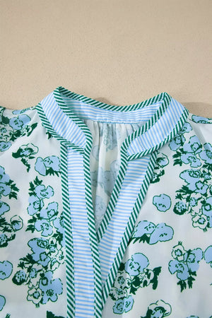 Floral print polyester blouse with striped trim and ruffled neckline detail