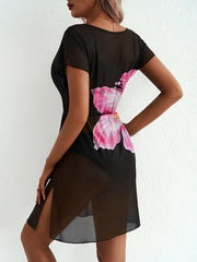 Black sheer mini dress with pink leaf print and side slit, short sleeves.