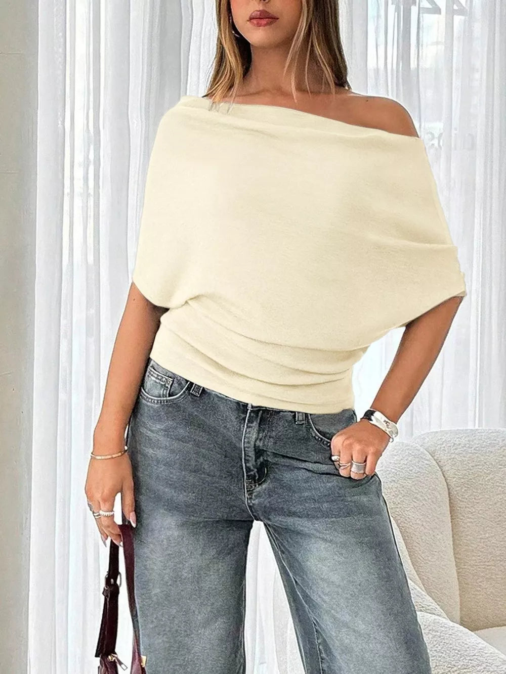 Apricot ruched off-shoulder knit t-shirt with dolman sleeves and cinched waist.