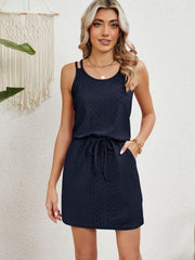 Navy blue eyelet crossover strap dress with drawstring waist and pockets