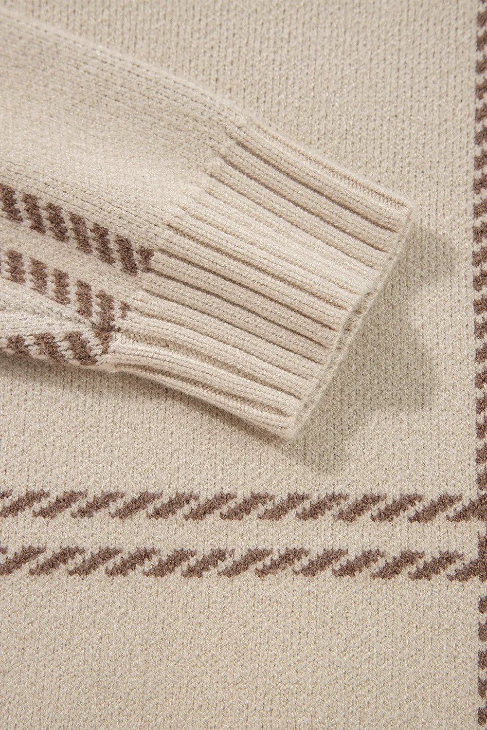 Tan knit crewneck pullover with brown gridline pattern and ribbed cuffs.