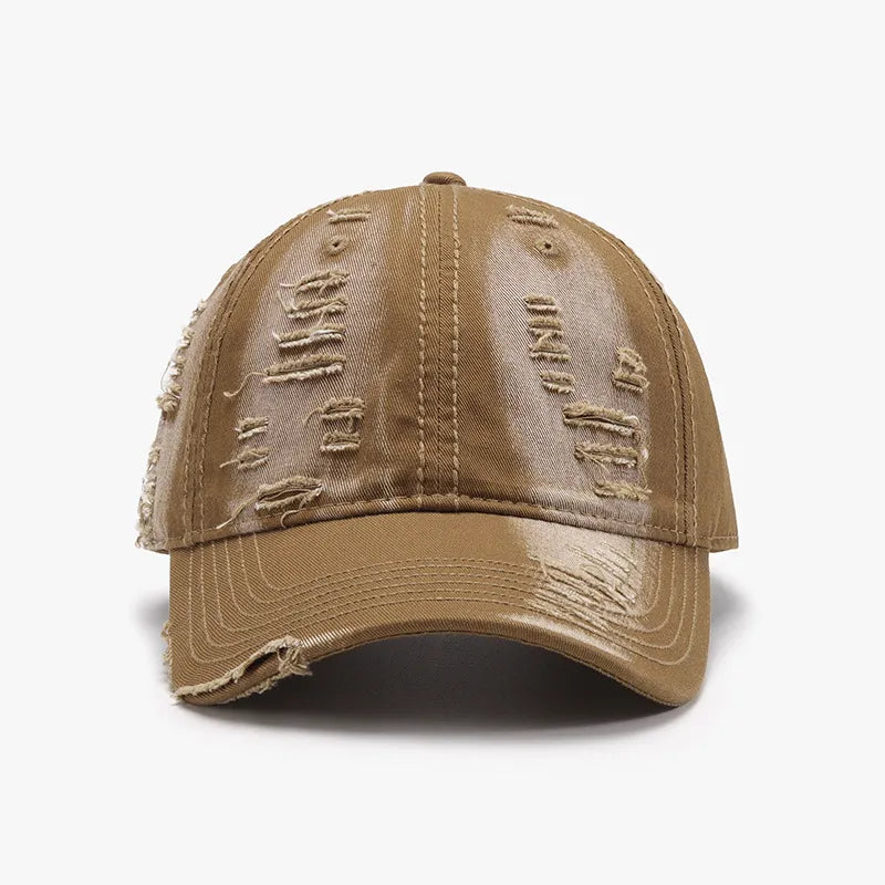 Distressed canvas baseball cap in camel with ripped details and frayed brim.