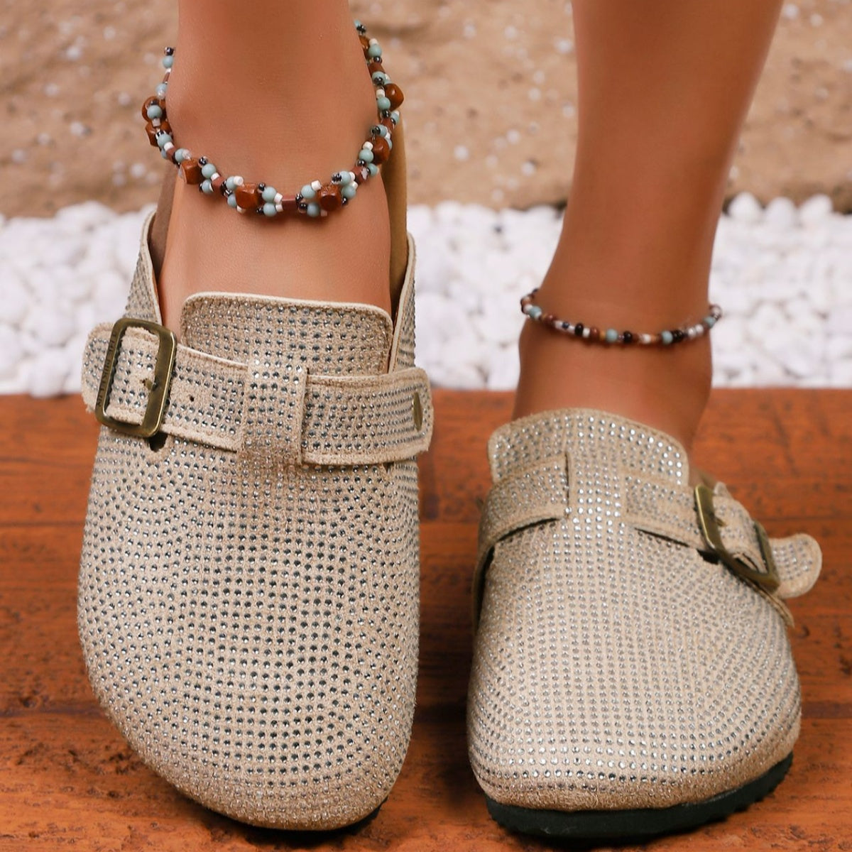 Rhinestone buckle slip-on mules in khaki with adjustable strap and buckle detail.