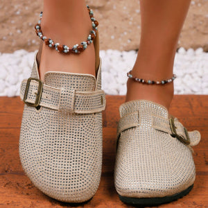 Rhinestone buckle slip-on mules in khaki with adjustable strap and buckle detail.