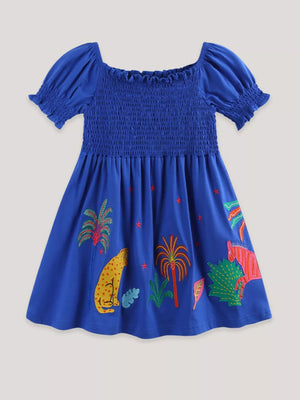 Blue cotton dress with smocked bodice, puff sleeves, and jungle animal embroidery.