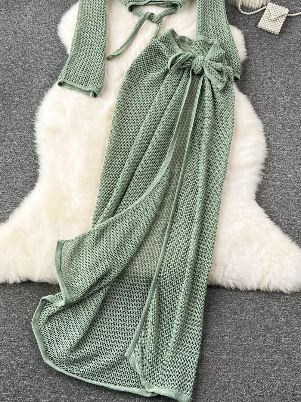 Green knit tied crop top and high slit skirt set with cutout detail.