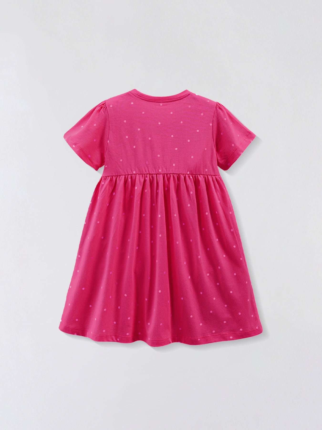 Pink cotton baby dress with scattered polka dots, crew neck, short sleeves, and gathered skirt.