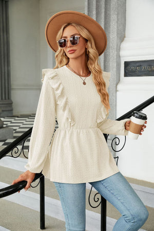 Ivory textured ruffle peplum blouse with long sleeves and a round neckline.
