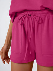 Deep Rose loungewear shorts with drawstring waist and pockets.