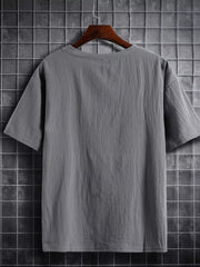 Grey cotton crew neck t-shirt with short sleeves and a textured finish.