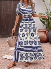 Maxi dress with blue floral print, cutout waist, short sleeves, and V-neck