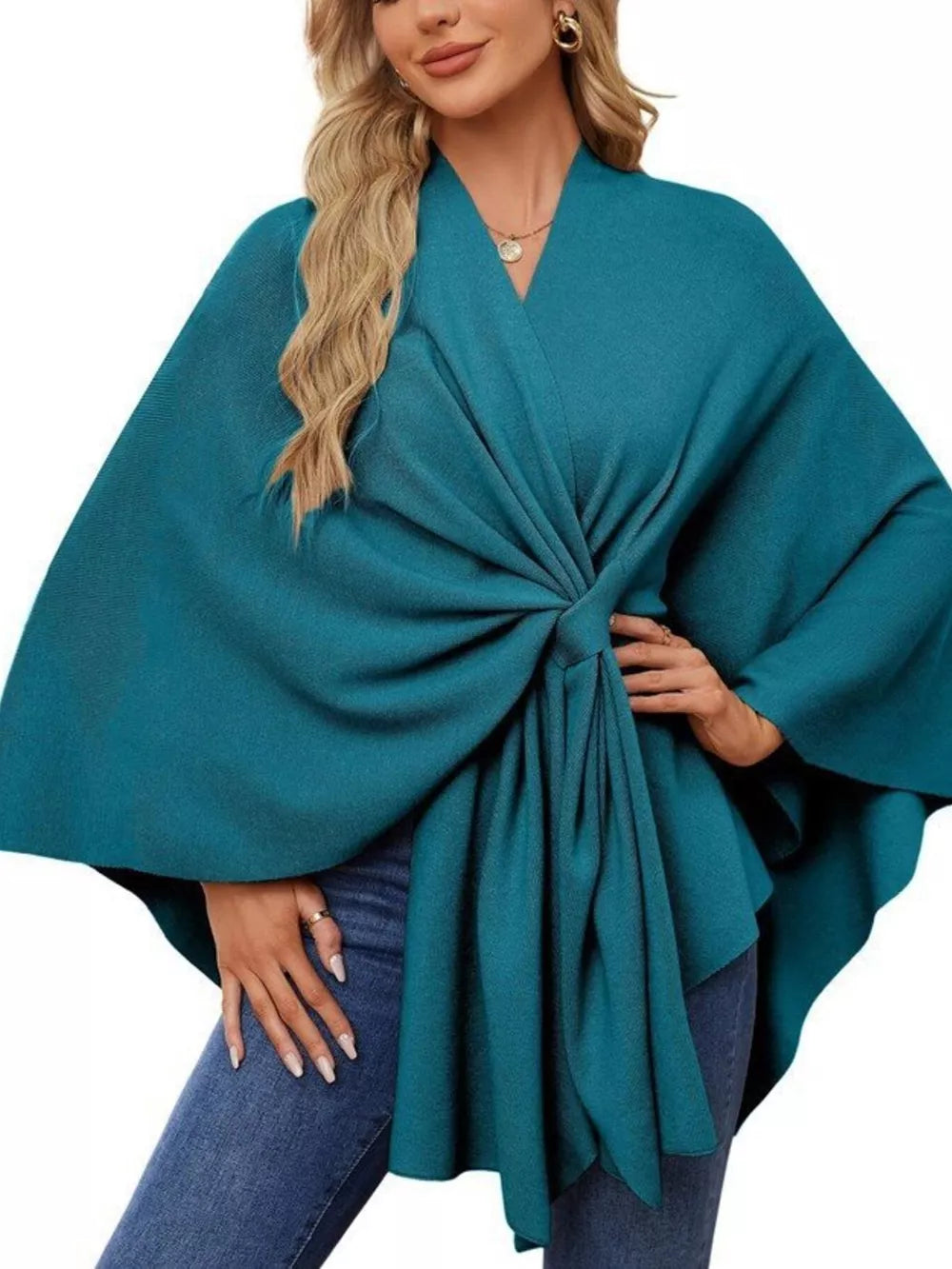 French blue knit cape top with draped elegance and tie-front detail.