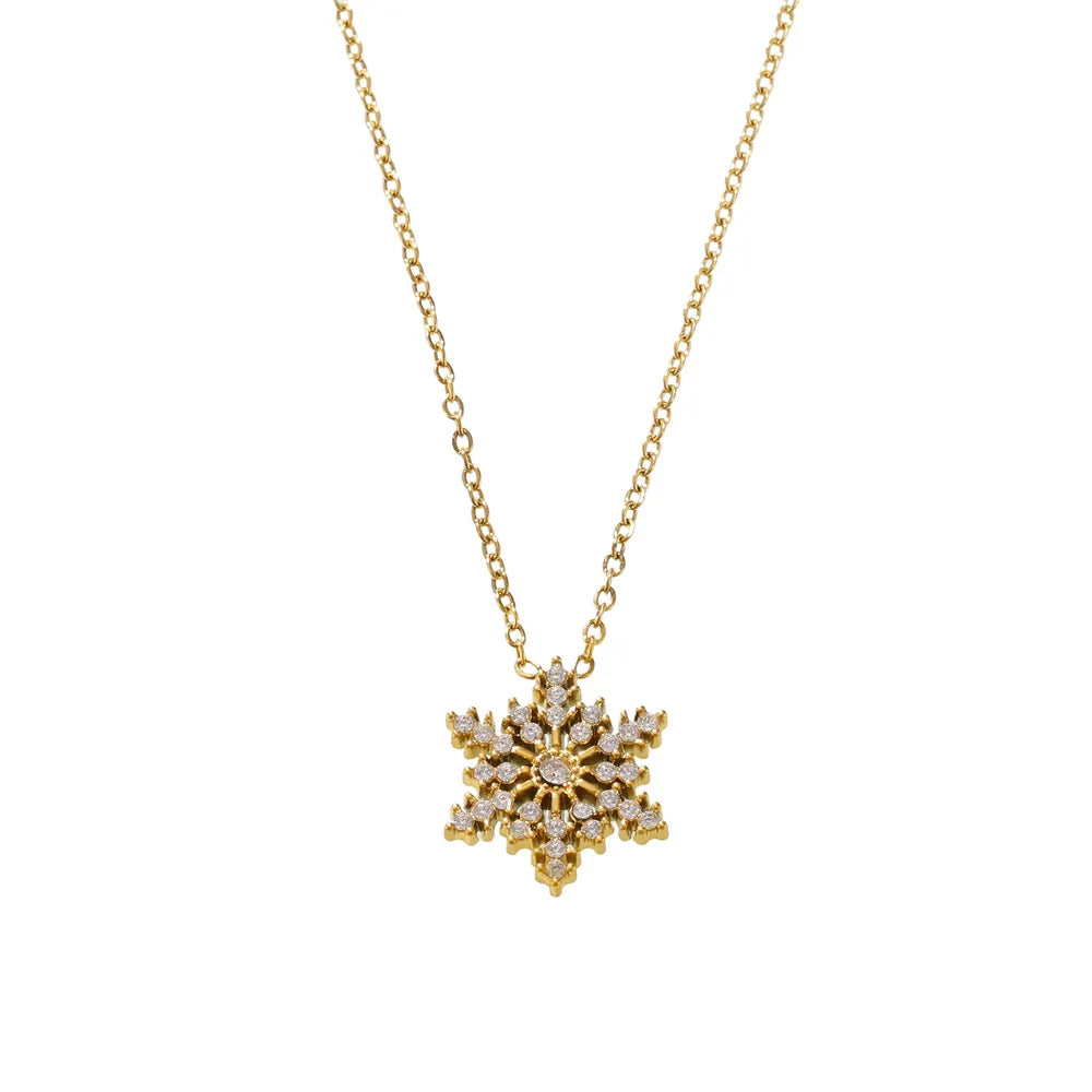 Gold snowflake pendant necklace with clear crystal accents on a delicate chain.