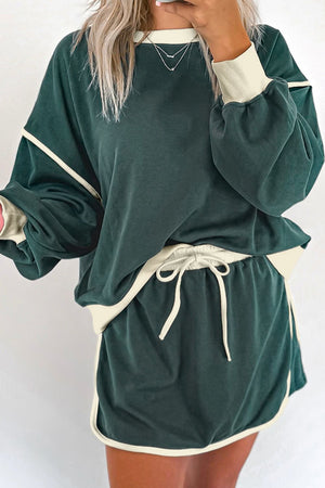 Dark green sweatshirt and skort set with cream contrast trim and drawstring waist.