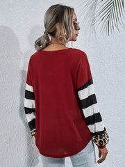 Waffle knit top in wine with striped and leopard print sleeves.