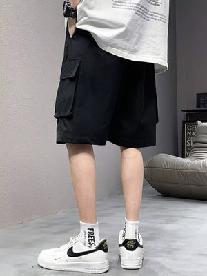 Black relaxed fit cargo shorts with side pockets and drawstring detail.
