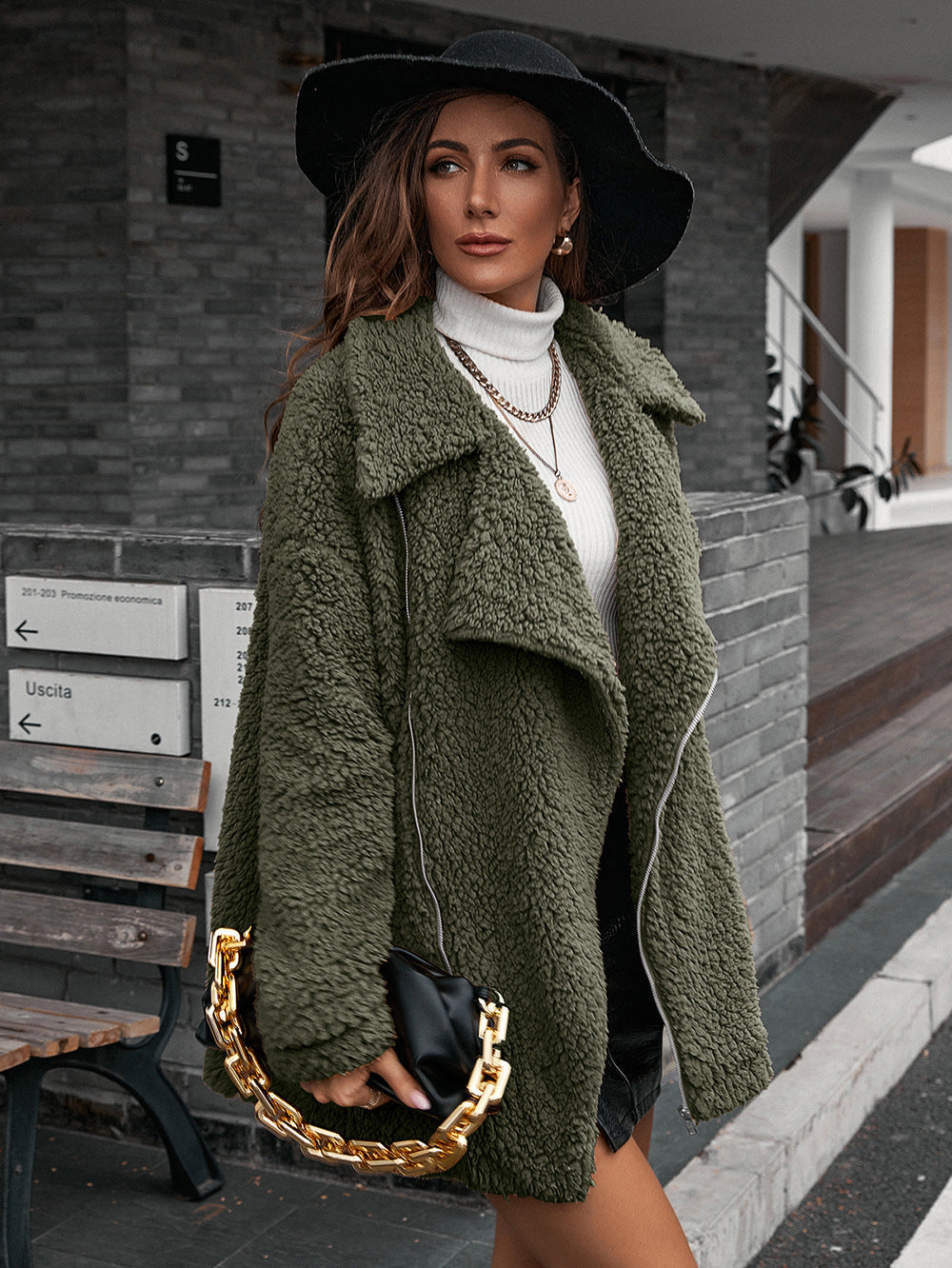 Green teddy moto jacket with asymmetrical zip and collared neckline.