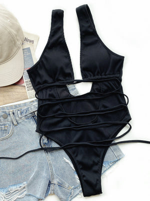 Black ribbed one-piece swimsuit with plunging neckline, cut-out detail and wrap tie closure.