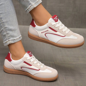 White and red lace-up sneakers with breathable mesh and suede accents.