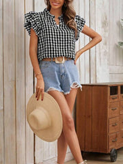 Black and white gingham ruffle sleeve blouse with a stand collar, styled with denim shorts.