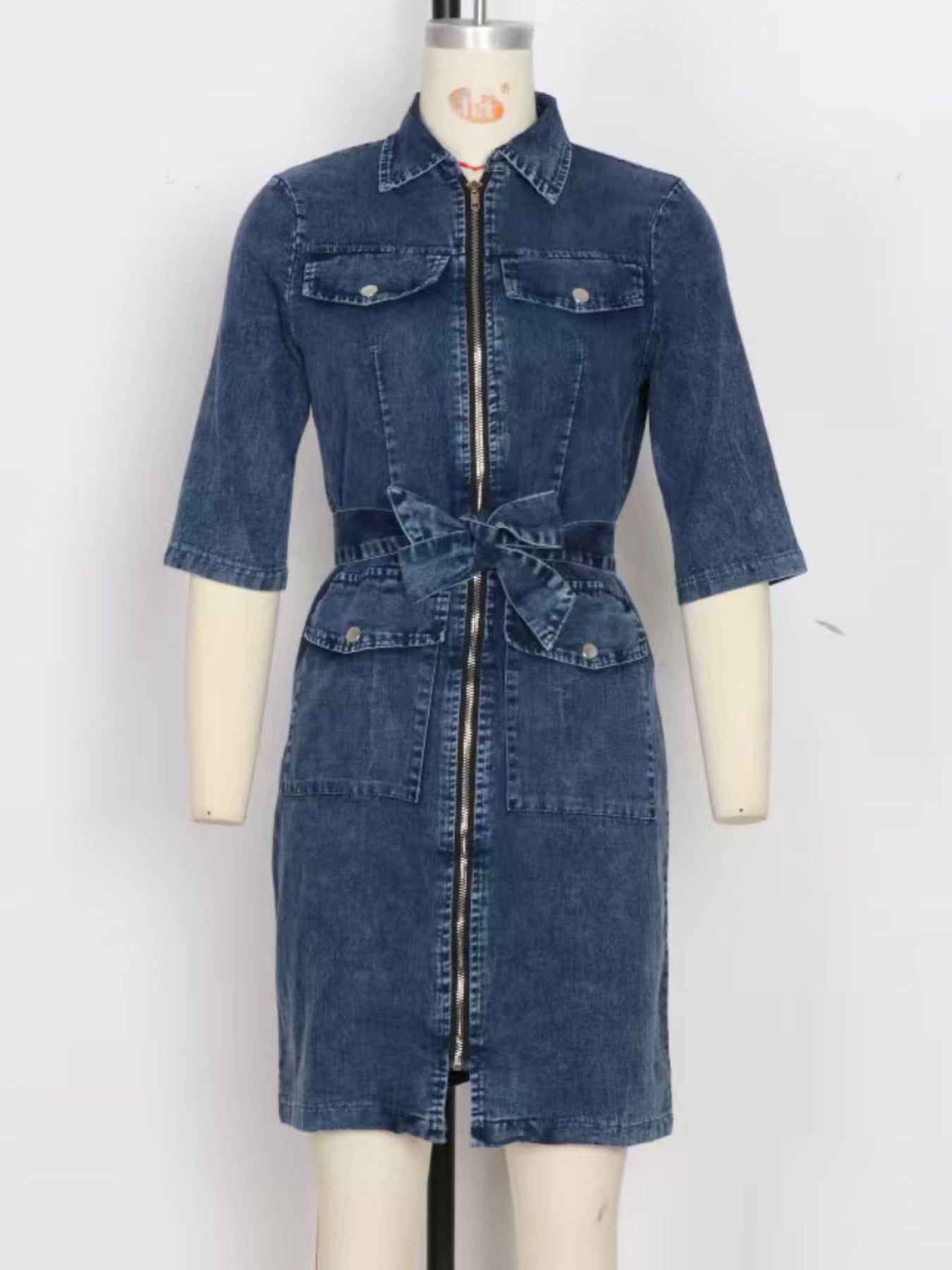 Denim shirt dress with zipper front, tie waist, and short sleeves in blue.
