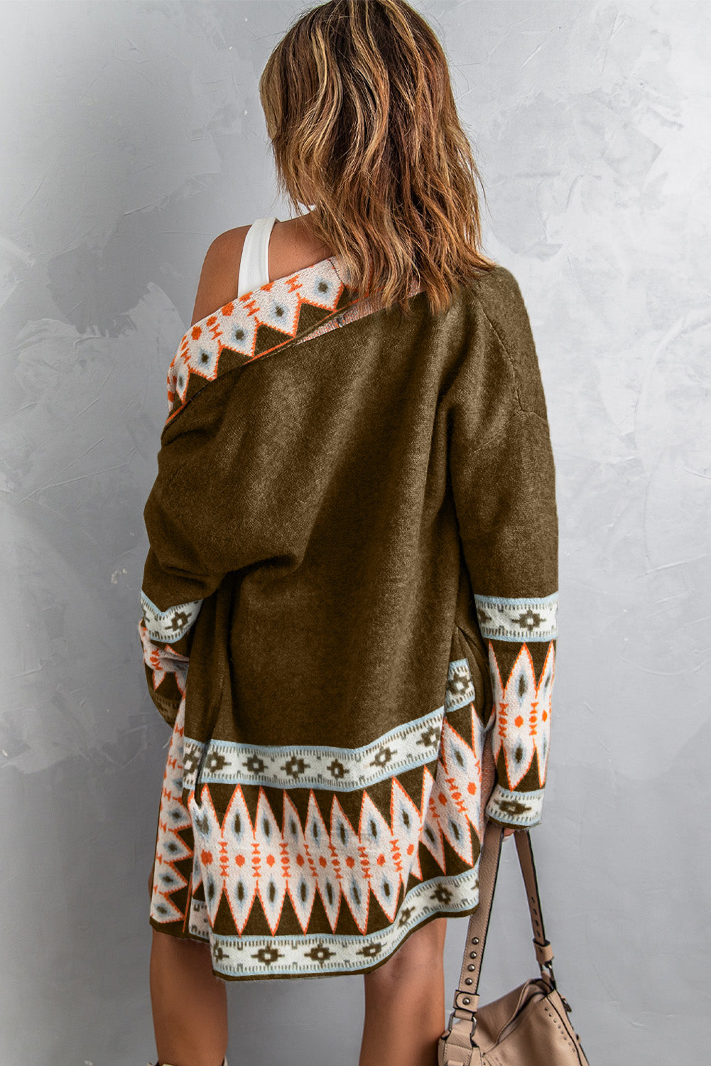 Brown knit cardigan with geometric trim on collar and cuffs, open front, long sleeves.