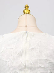 White midi dress with floral applique, boat neck, and zipper detail.