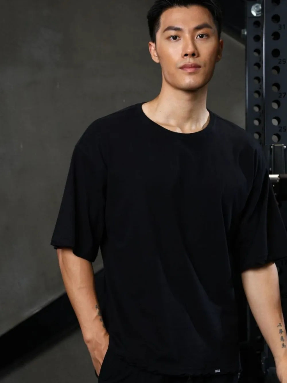 Black oversized tee with raw edges and distressed details.