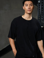 Black oversized tee with raw edges and distressed details.