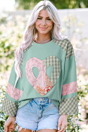 Patchwork heart raglan top in tan with plaid sleeves and floral accents.