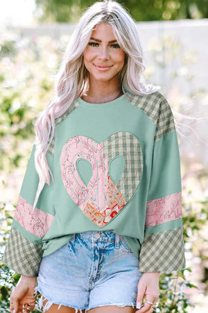 Patchwork heart raglan top in tan with plaid sleeves and floral accents.