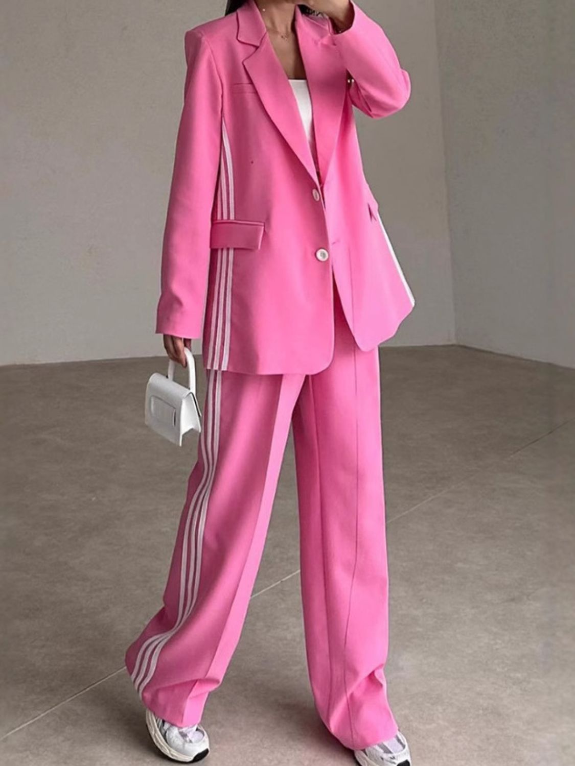 Hot Pink pant suit with white track stripes on blazer and pants.