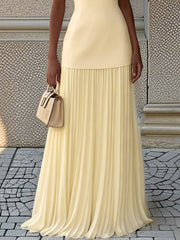 Yellow sleeveless top and pleated maxi skirt set with a boat neck.