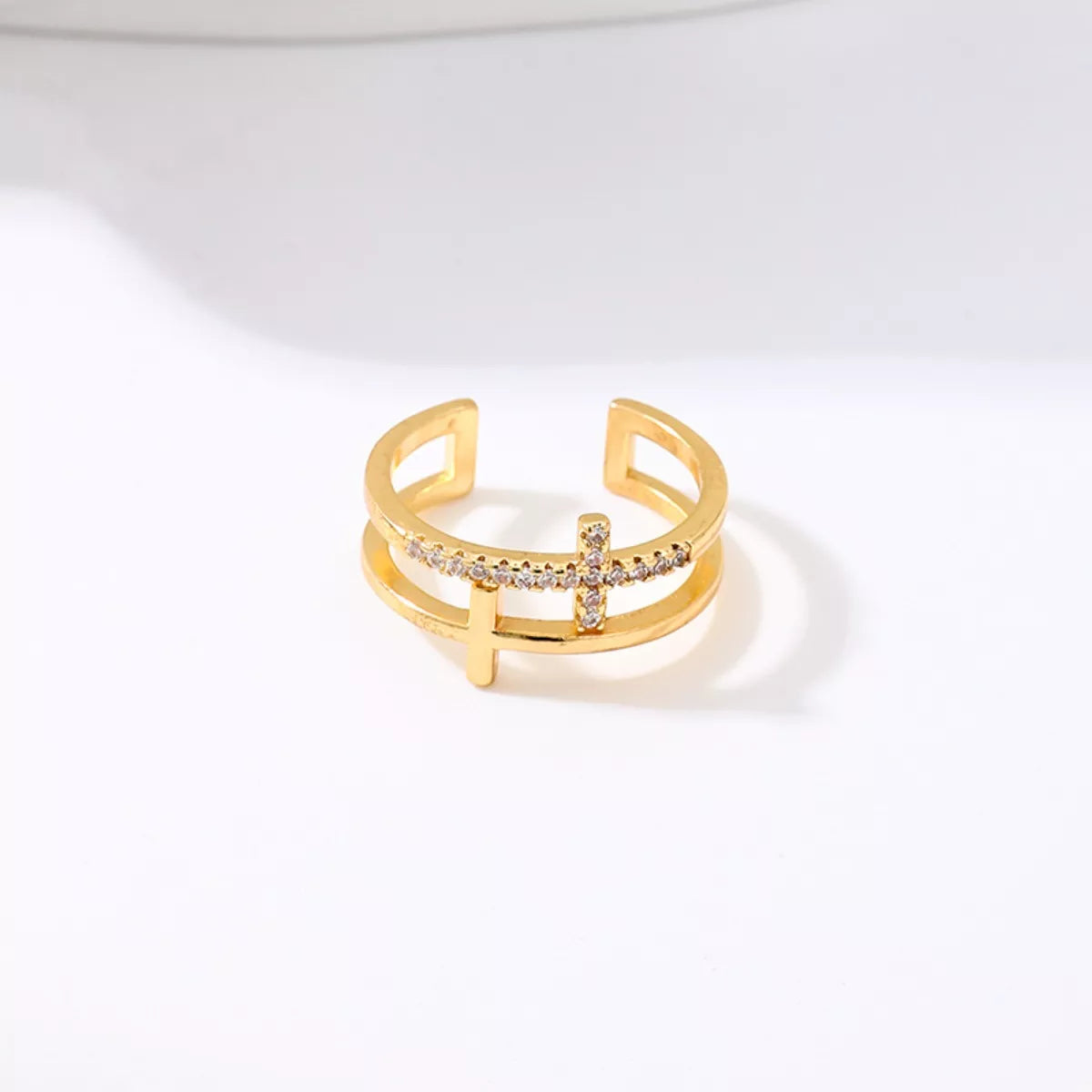 Golden open ring with rhinestone cross detail, 18K gold-plated.