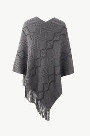 Charcoal knit poncho with geometric pattern and fringe detail