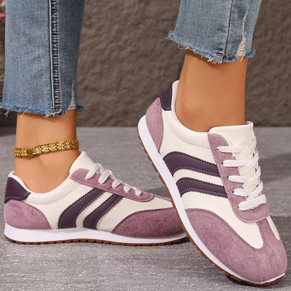 Two-tone suede lace-up sneakers in pink purple with white laces and soles.