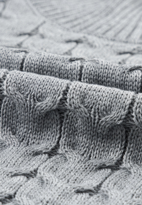 Gray cable knit turtleneck capelet sweater with acrylic material.
