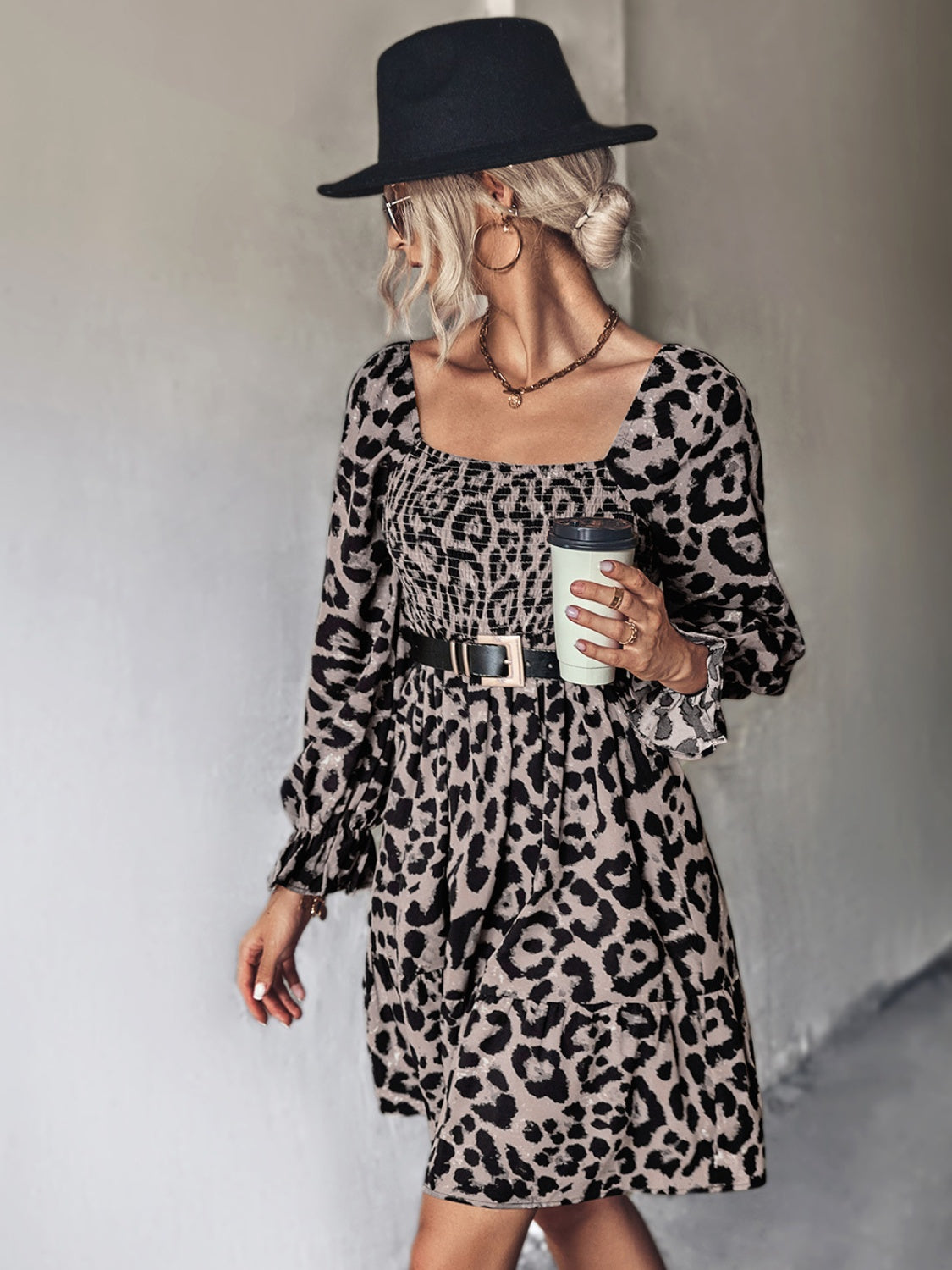 Smocked bodice leopard print mini dress with square neckline and tiered skirt.