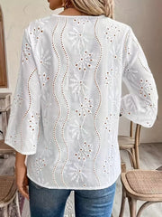 White blouse featuring lace detail and eyelet