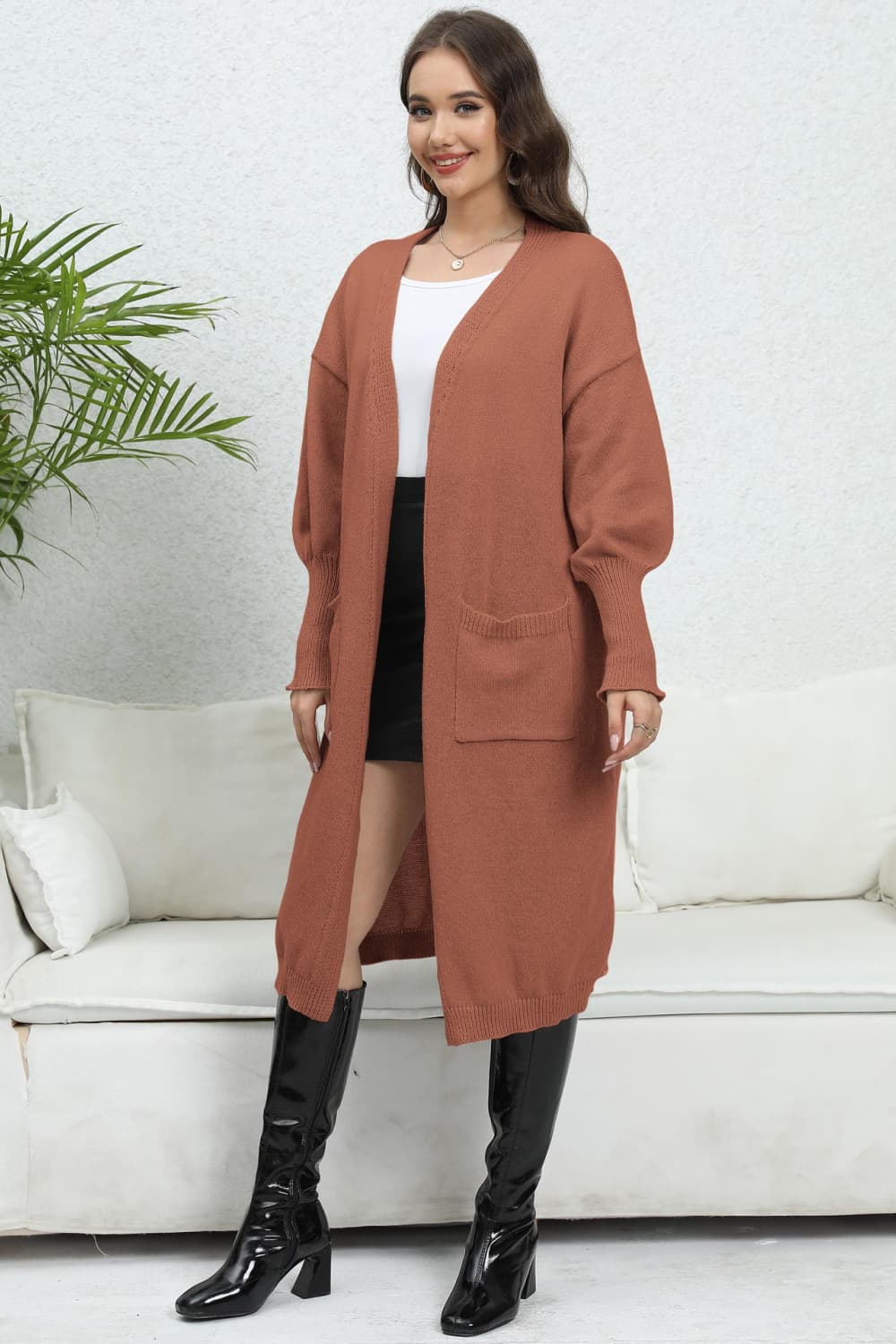 Oversized pocketed knit cardigan in caramel with long sleeves and open front.