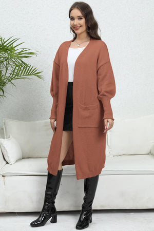 Oversized pocketed knit cardigan in caramel with long sleeves and open front.