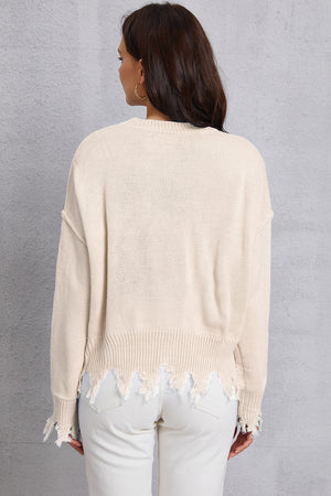 Cream knit sweater with distressed hem and cuffs, crew neck, long sleeves.