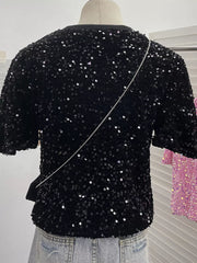 Black sequin t-shirt with crew neck and short sleeves, embellished with iridescent sequins.
