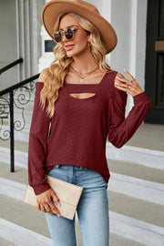 Burgundy textured open shoulder blouse with keyhole neckline and long sleeves.