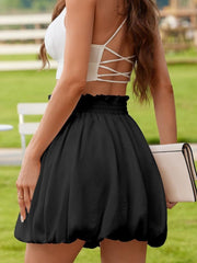 Black bubble hem mini skirt with ruffled elastic waistband.