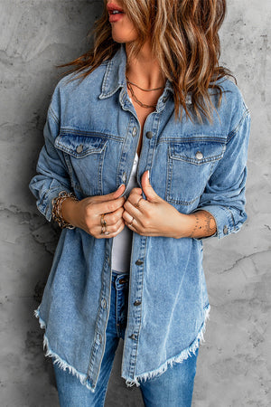 Oversized denim shirt jacket in dark blue with frayed hem and button front.
