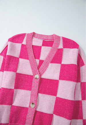 Hot pink and light pink checkerboard knit cardigan with V-neck and button closure.