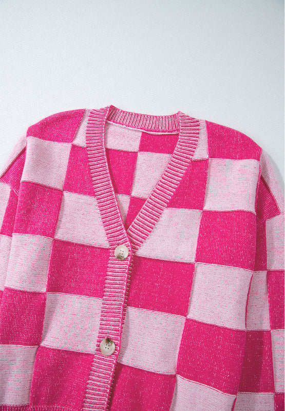 Hot pink and light pink checkerboard knit cardigan with V-neck and button closure.