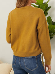 Mustard yellow knit cardigan with V-neck and button front, long sleeves.