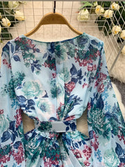 Light blue floral ruffle hem wrap mini dress with cinched waist and long sleeves.